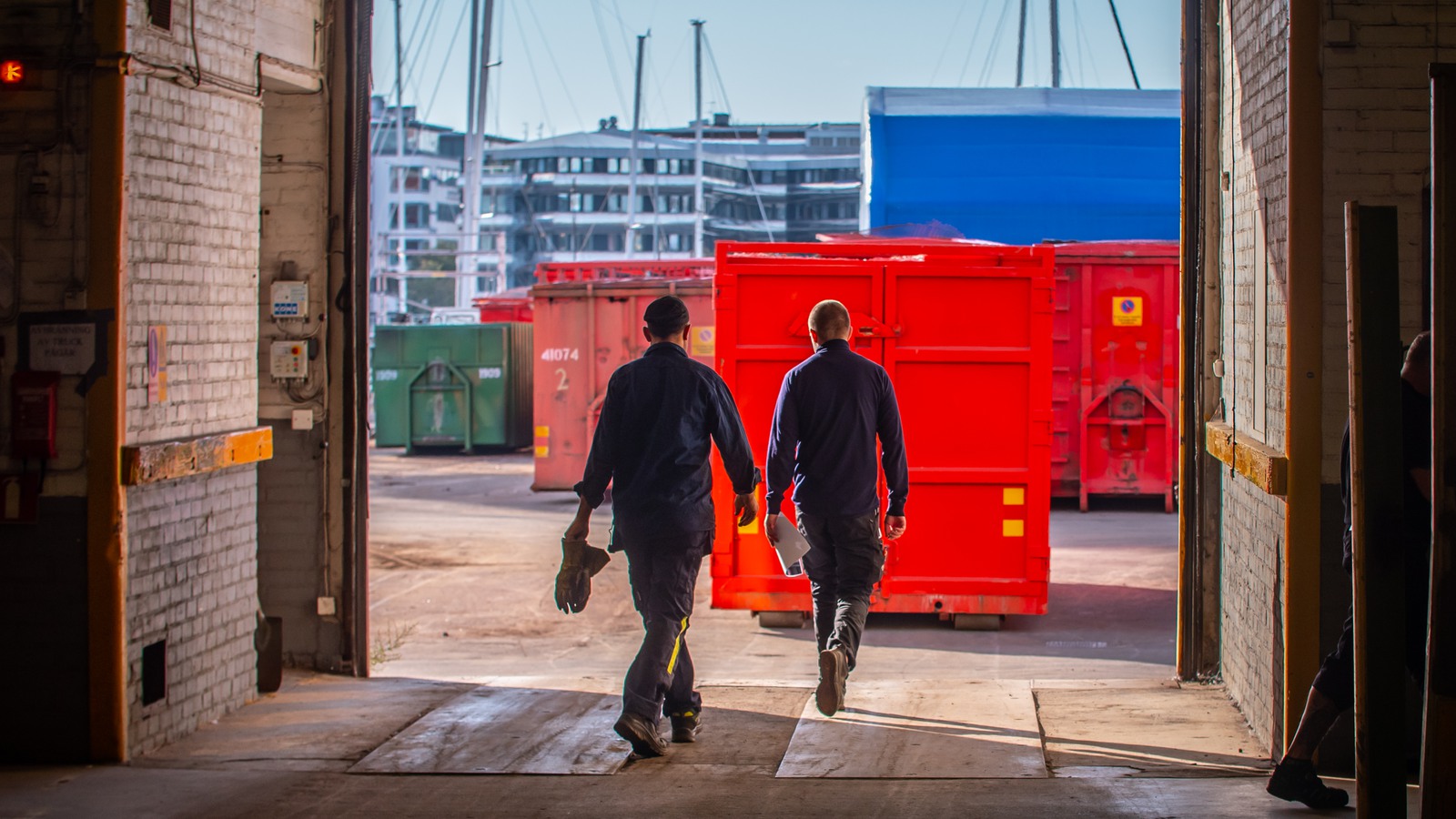 män går mot container